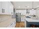 Bright kitchen with an island, quartz countertops, stainless steel appliances and ample cabinet space at 217 Lucca Dr, Summerville, SC 29486