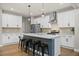 Modern kitchen with a central island, stainless steel appliances, and stylish pendant lighting at 217 Lucca Dr, Summerville, SC 29486