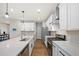 Modern kitchen with stainless appliances, quartz countertops, and an island with a sink and dishwasher at 217 Lucca Dr, Summerville, SC 29486