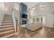 Bright living room with a fireplace, high ceilings, and large windows showcasing the sunset view at 217 Lucca Dr, Summerville, SC 29486