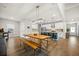 Open floor plan with kitchen, dining area with a long wooden table, and bar seating at kitchen island at 217 Lucca Dr, Summerville, SC 29486