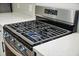 Close-up of a modern stainless-steel stovetop with gas burners and quartz countertops at 217 Lucca Dr, Summerville, SC 29486