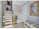 Welcoming foyer with staircase, stylish mirror, tiled floor, and bench seating at 217 Slipper Shell Ct, Mount Pleasant, SC 29464