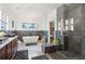 Bright bathroom featuring modern soaking tub, walk in shower, double vanity, and stylish tile flooring at 231 Bayview Dr, Mount Pleasant, SC 29464