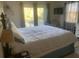 Bright bedroom with a spacious bed, balcony access, and sunny views at 24 Commons Ct, Isle of Palms, SC 29451