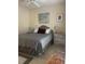 Cozy bedroom featuring a comfortable bed with blue striped bedding, a ceiling fan, and neutral decor at 24 Commons Ct, Isle of Palms, SC 29451