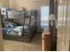 Comfortable bunk room with a grey bunk bed, decorative rug, and stylish accents at 24 Commons Ct, Isle of Palms, SC 29451