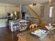 Well-lit kitchen features stainless steel appliances, an island with seating, and adjacent staircase at 24 Commons Ct, Isle of Palms, SC 29451