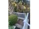 Convenient outdoor shower with a wooden base and white fencing, surrounded by lush tropical landscaping at 24 Commons Ct, Isle of Palms, SC 29451