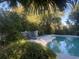 Inviting outdoor pool area with lush greenery, comfortable seating, and a serene ambiance for relaxation at 24 Commons Ct, Isle of Palms, SC 29451