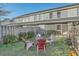 Backyard area features lawn, a fire pit, Adirondack chairs, and a privacy fence at 249 Brookshire Rd, Goose Creek, SC 29445
