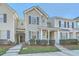 View of the exterior featuring the covered entryway of the townhome and the landscaped front yard at 249 Brookshire Rd, Goose Creek, SC 29445