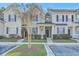 Inviting exterior view of townhomes with manicured lawns, blue shutters, and covered entryway at 249 Brookshire Rd, Goose Creek, SC 29445