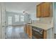 Bright, open kitchen with wood cabinets and a view into the living area at 249 Brookshire Rd, Goose Creek, SC 29445