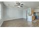 View of the living room featuring hardwood floors, natural light, and a kitchen area in the back at 249 Brookshire Rd, Goose Creek, SC 29445