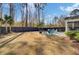 A spacious backyard with a fire pit area and a dark wooden fence in a wooded area at 2825 Backman St, Mount Pleasant, SC 29466