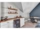 Chic bar area with a wooden countertop, beverage fridge, stylish shelving, and a cozy dining space at 2825 Backman St, Mount Pleasant, SC 29466