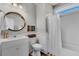 Bright bathroom with a shower, a vanity with a round mirror, and modern fixtures, blending style and functionality at 2825 Backman St, Mount Pleasant, SC 29466