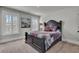 A bedroom with large bright windows, featuring a dark wood frame bed and quilt bedding at 2825 Backman St, Mount Pleasant, SC 29466