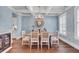 Charming dining room featuring blue leaf wallpaper, coffered ceiling, and a rustic wood table at 2825 Backman St, Mount Pleasant, SC 29466