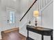 Elegant entryway with dark wood floors, white paneled walls, staircase, and decorative console table at 2825 Backman St, Mount Pleasant, SC 29466