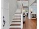 Inviting entryway with hardwood floors, staircase with white risers, and stylish console table at 2825 Backman St, Mount Pleasant, SC 29466