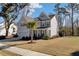 Gray two-story home featuring an attached garage, mature landscaping, and a welcoming front porch at 2825 Backman St, Mount Pleasant, SC 29466
