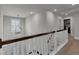 Bright upstairs hallway with white banisters, neutral walls, and carpeted flooring, creating a seamless flow throughout the home at 2825 Backman St, Mount Pleasant, SC 29466