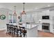 Well-lit kitchen featuring a center island with seating, white cabinets, and modern appliances at 2825 Backman St, Mount Pleasant, SC 29466