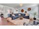 Comfortable living room with a large sectional sofa, decorative wall decor, and a cozy rug on hardwood floors at 2825 Backman St, Mount Pleasant, SC 29466