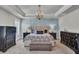 A spacious primary bedroom features a tray ceiling, chandelier, and elegant furnishings at 2825 Backman St, Mount Pleasant, SC 29466