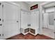 Mud room with custom shelving, storage baskets and convenient hooks with view to modern bathroom at 2825 Backman St, Mount Pleasant, SC 29466