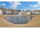View of a neighborhood pond with a fountain and several houses bordering it at 2825 Backman St, Mount Pleasant, SC 29466