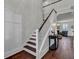 Elegant staircase with wooden treads, white risers, and a view into the living space offering a welcoming transition at 2825 Backman St, Mount Pleasant, SC 29466