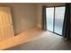 Bright bedroom with neutral carpet, sliding glass door with access to the outside and new paint at 291 Sea Cloud Cir # 291, Edisto Island, SC 29438