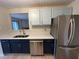 Well-lit modern kitchen with stainless steel appliances, two-toned cabinets, and a view to the dining area at 291 Sea Cloud Cir # 291, Edisto Island, SC 29438