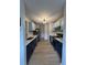 Bright kitchen featuring two-toned cabinets, stainless steel appliances, and stylish modern lighting at 291 Sea Cloud Cir # 291, Edisto Island, SC 29438