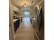 Galley kitchen with stainless steel appliances, modern lighting, and a view to a dining area with lots of light at 291 Sea Cloud Cir # 291, Edisto Island, SC 29438