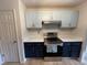 Cozy kitchen featuring two-tone cabinets, quartz countertops, stainless steel appliances, and modern lighting at 291 Sea Cloud Cir # 291, Edisto Island, SC 29438