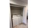 Laundry room with stacked washer and dryer and a convenient storage shelf at 291 Sea Cloud Cir # 291, Edisto Island, SC 29438