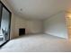 Living area features plush carpeting, sliding glass doors to deck, and modern fireplace at 291 Sea Cloud Cir # 291, Edisto Island, SC 29438