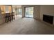 Open living area includes a fireplace, bar stools, and access to a large deck at 291 Sea Cloud Cir # 291, Edisto Island, SC 29438