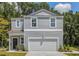 Charming two-story home with a neatly maintained lawn and attached two car garage in a suburban neighborhood at 303 Pine Crest View Dr, Summerville, SC 29486