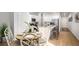 Open dining area and kitchen featuring hardwood floors and neutral colors at 310 Tiliwa St, Summerville, SC 29486