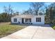 Charming single-story home with black door, black shutters, and a concrete driveway at 3113 Matipan Ave, North Charleston, SC 29405