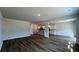 Spacious living room with stylish wood flooring, neutral paint, open-concept layout, and bright, natural light at 321 Blue Haw Dr, Moncks Corner, SC 29461