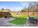 Backyard patio featuring a fire pit, outdoor furniture, pavers, grass and a wood privacy fence at 322 Equinox Cir, Ladson, SC 29456