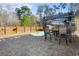 Backyard patio with a pergola, picnic table, outdoor chairs and a swimming pool in the background at 322 Equinox Cir, Ladson, SC 29456