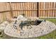 Backyard koi pond with stone waterfall, decorative rocks, rock and gravel base and a wooden privacy fence at 322 Equinox Cir, Ladson, SC 29456