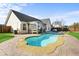 Backyard swimming pool with a patio, outdoor kitchen, privacy fence, and well-maintained landscaping at 322 Equinox Cir, Ladson, SC 29456